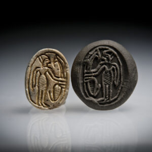 A Canaanite Steatite Scarab Seal Engraved with a Male Holding a Lotus