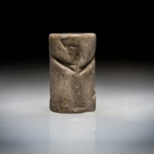 A Mesopotamian Pink Jasper Cylinder Seal with Winged Griffins