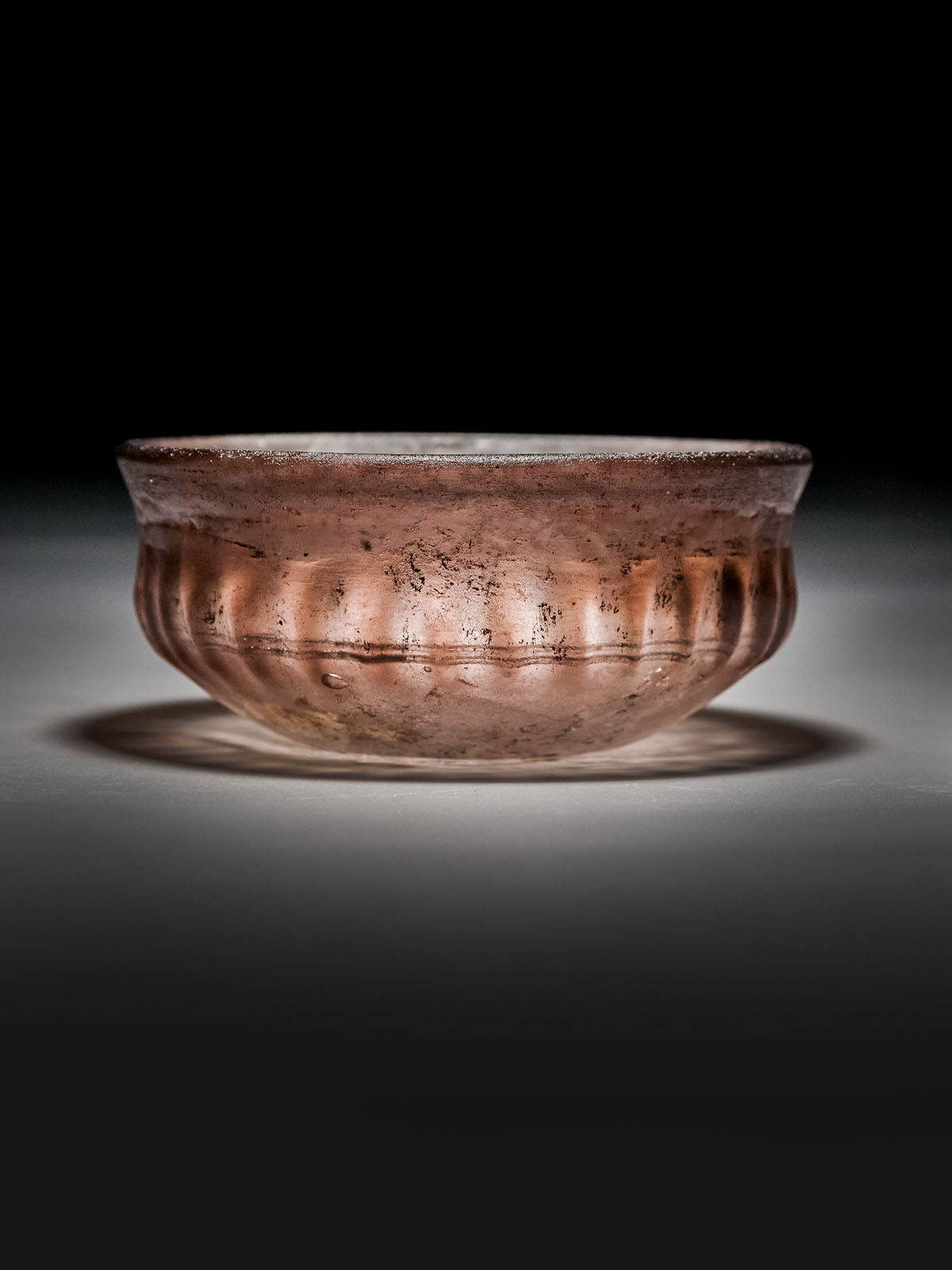 An Aubergine Ribbed Glass bowl