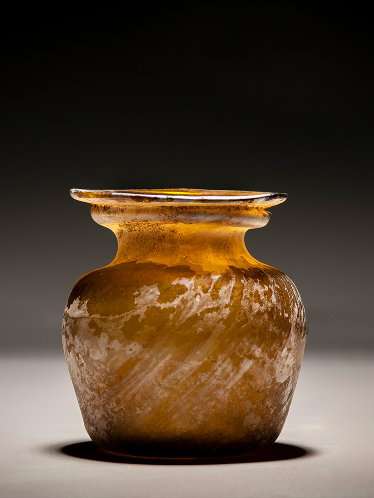 A Roman Amber Glass Jar with Diagonal Ribbing