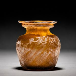 A Roman Amber Glass Jar with Diagonal Ribbing